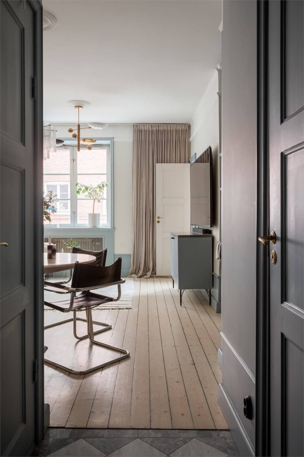 A Small Stockholm Apartment with a Blue Shaker Kitchen 13 peek into living room