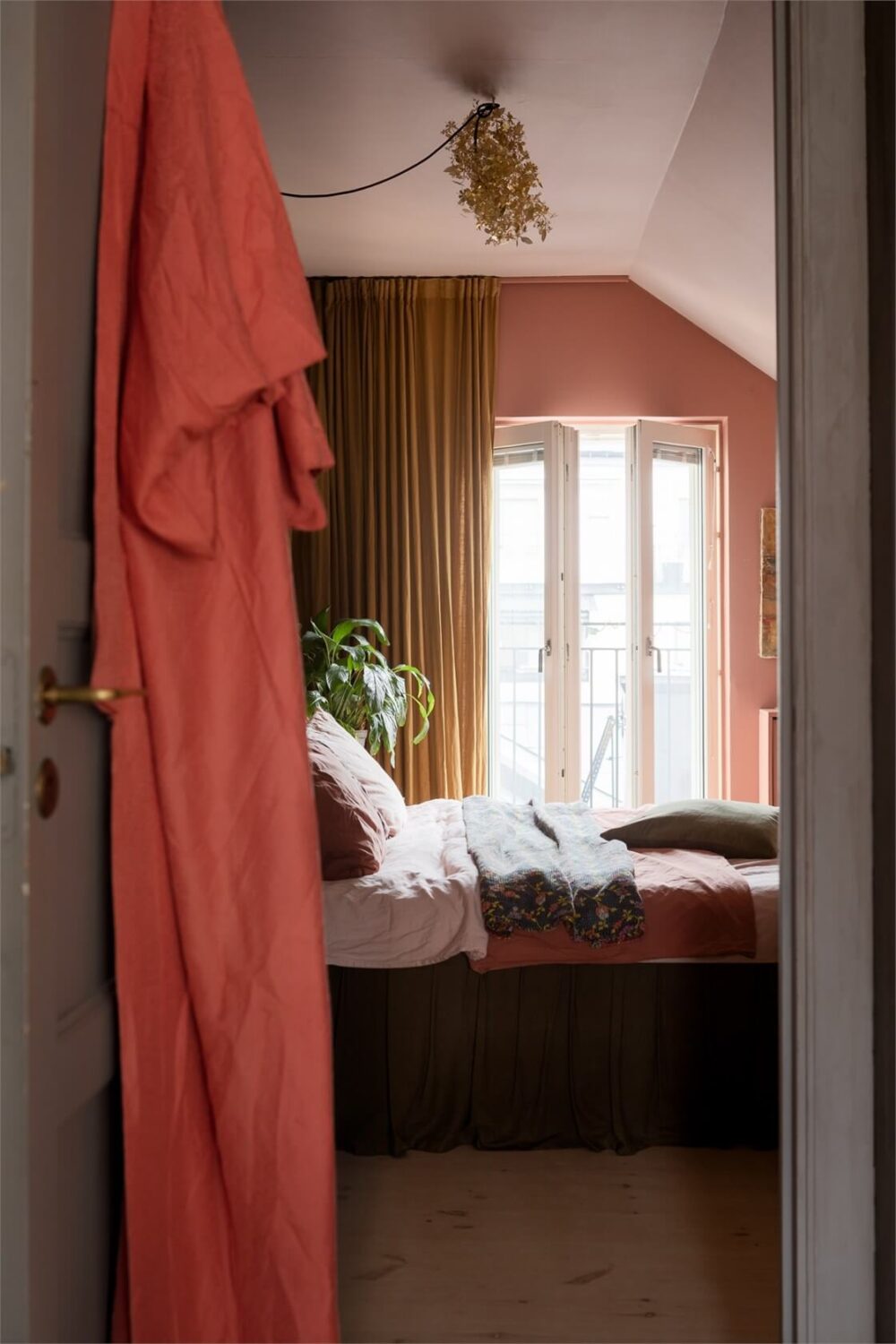 A Colorful Family Attic Apartment in Stockholm 21 pink attic bedroom ochre curtains