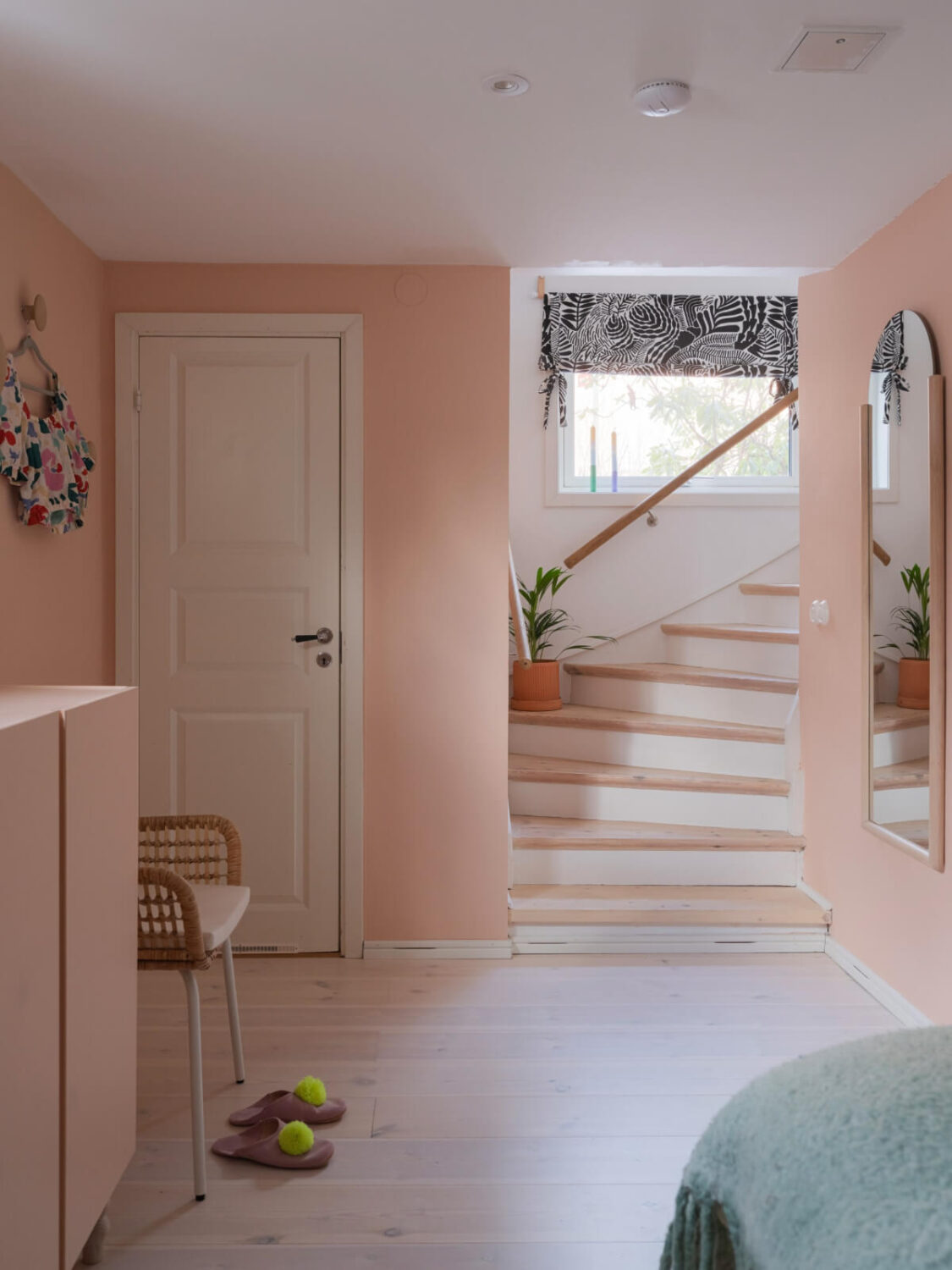 Colorful Decor in a Charming Family Duplex Apartment in Stockholm 23 pink basement bedroom with staircase