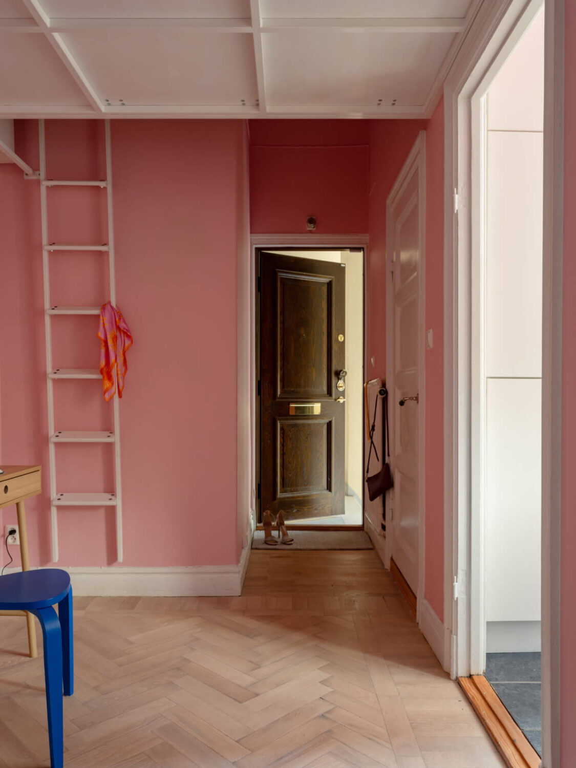 A Small Pink and Blue Apartment with High Ceilings in Stockholm 20 pink hallway herringbone floor