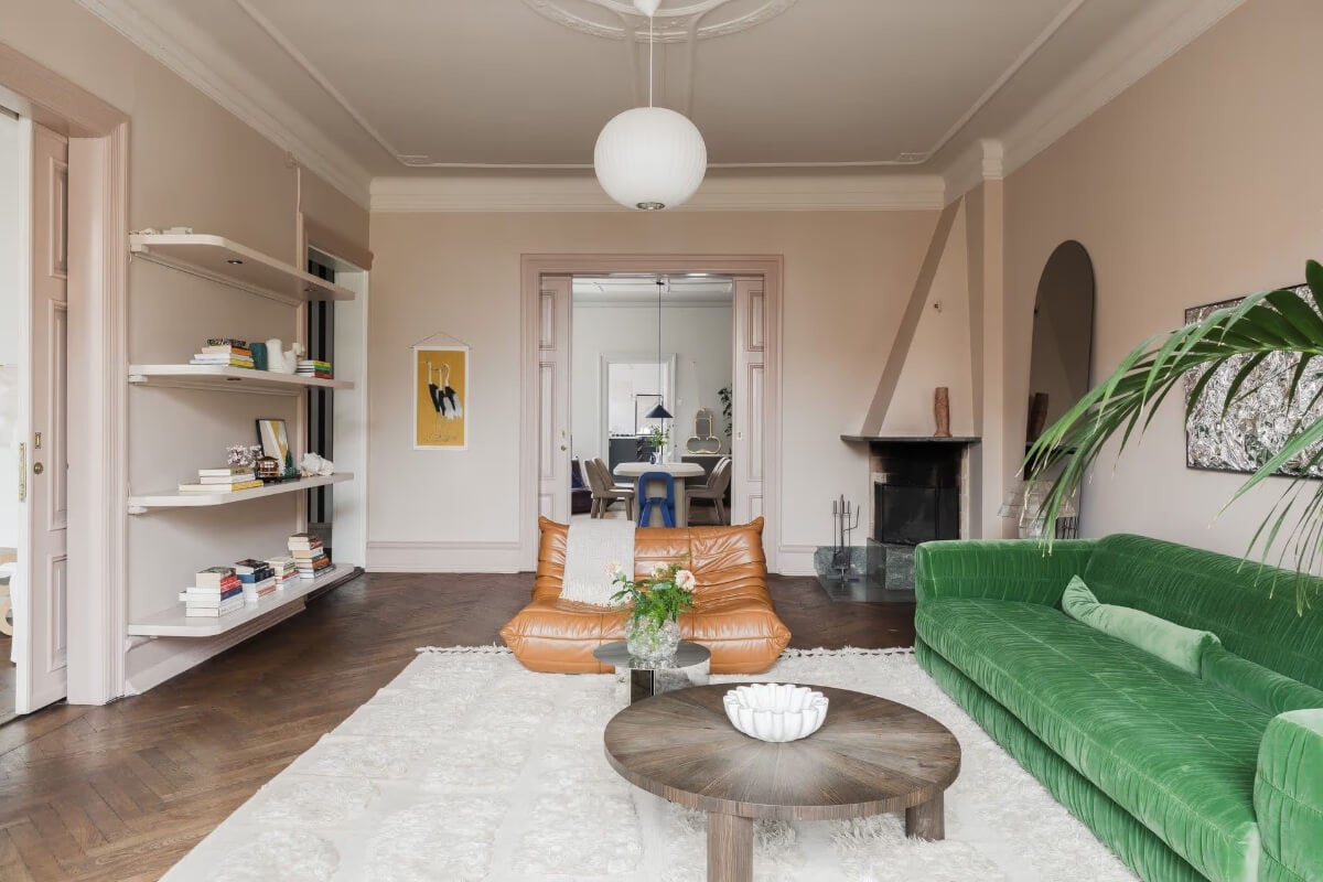 Grand Rooms and Period Features in a Malmö Apartment 7 pink living room with fireplace and bookshelves
