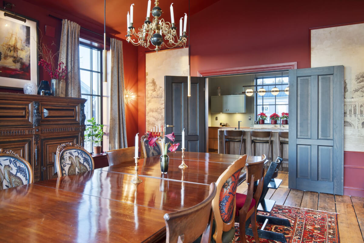 English Manor Style Interiors in a New Swedish Home with Lake Views 10 red dining room double wooden doors to kitchen