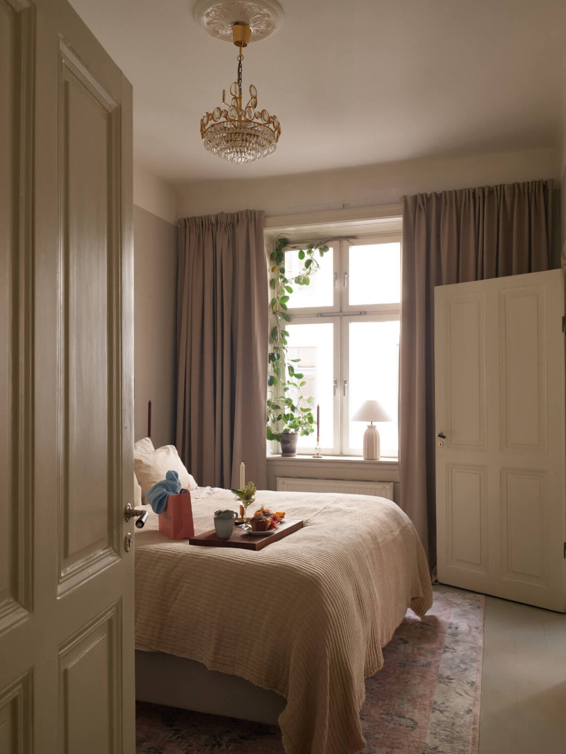 A Calm Gray Color Palette in a Charming Stockholm Apartment 8 serene light gray bedroom