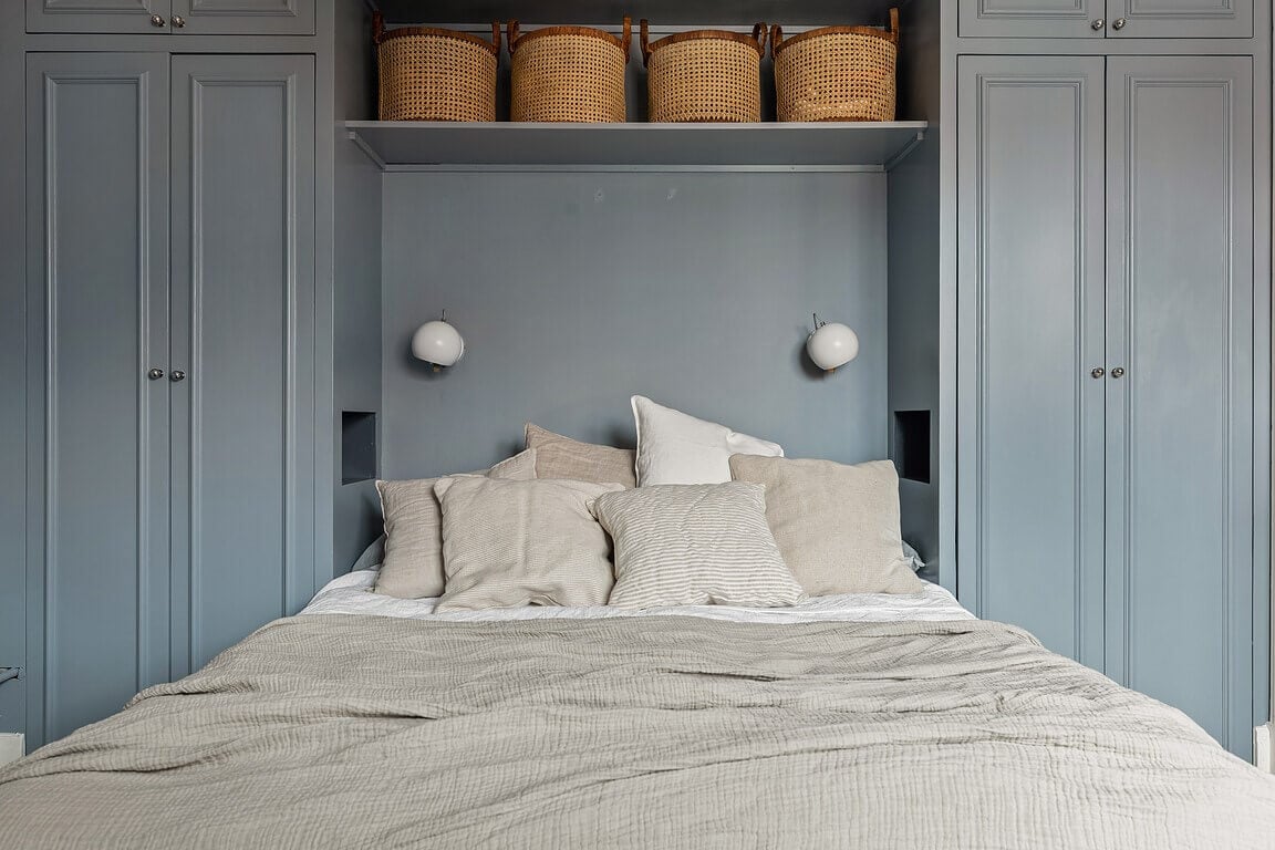 A Stockholm Apartment with a Light Yellow Kitchen 18 shelf above the bed