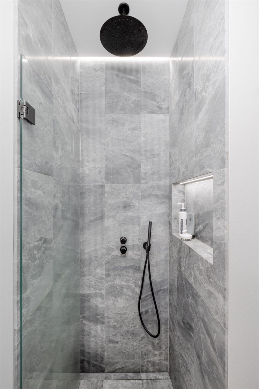 A Small Stockholm Apartment with a Blue Shaker Kitchen 23 shower black fittings