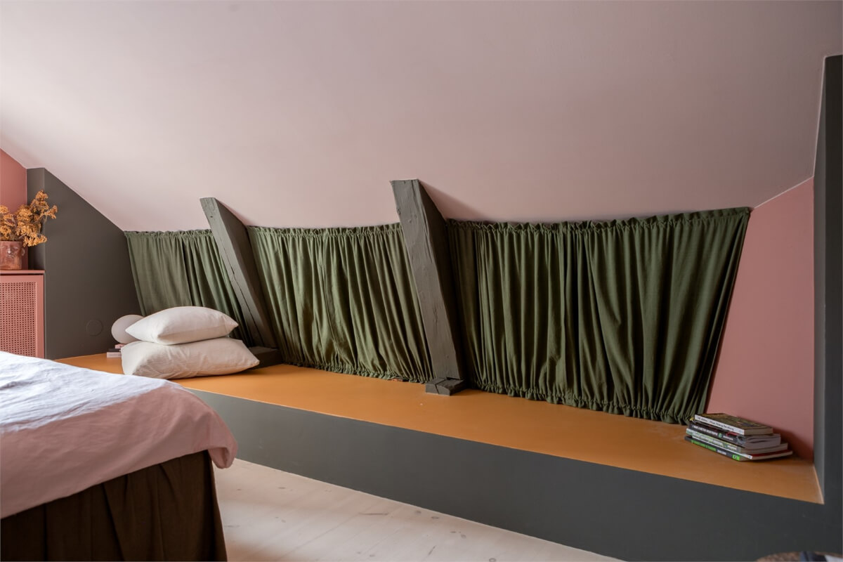 A Colorful Family Attic Apartment in Stockholm 26 slanted ceiling bench attic bedroom