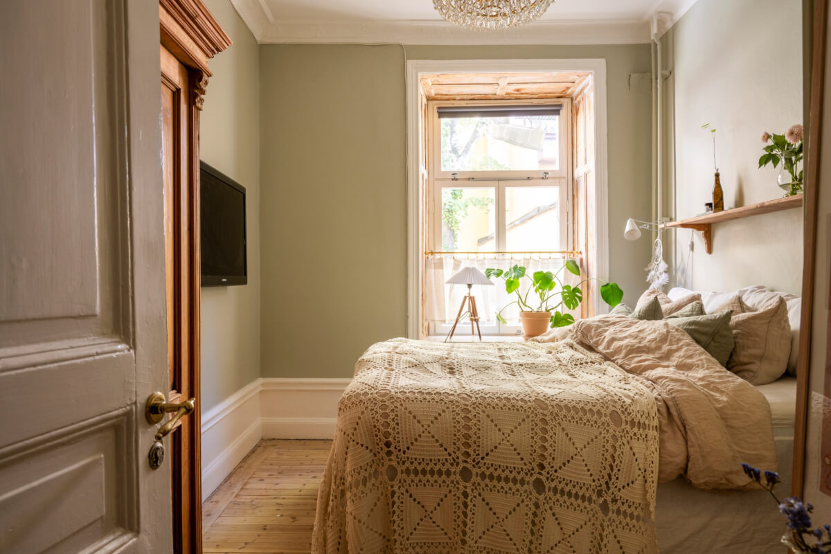 A Cozy Small Apartment with Period Features and Lots of Storage 18 small green bedroom wooden floorboards