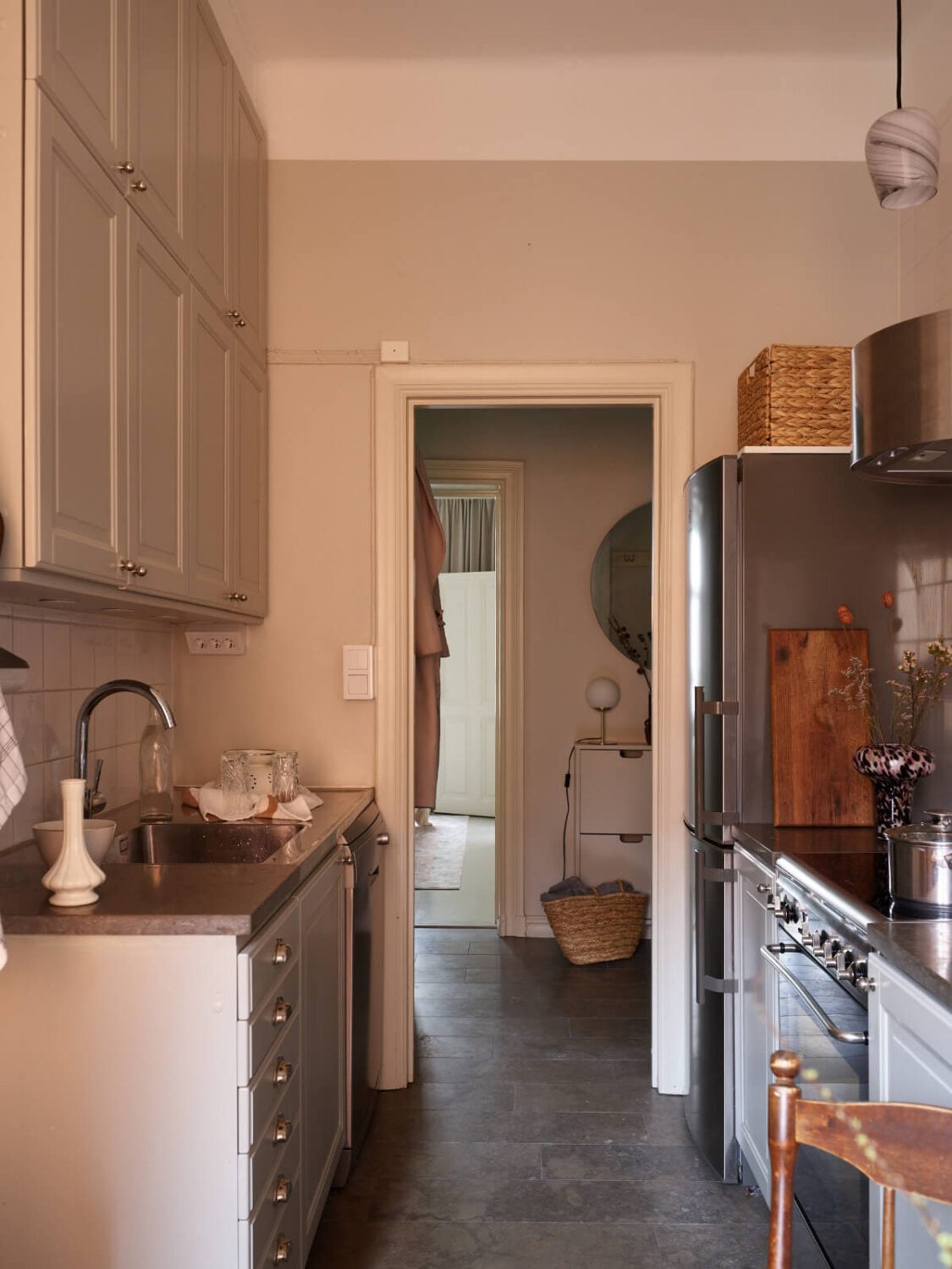 A Calm Gray Color Palette in a Charming Stockholm Apartment 16 small kitchen dark stone floor