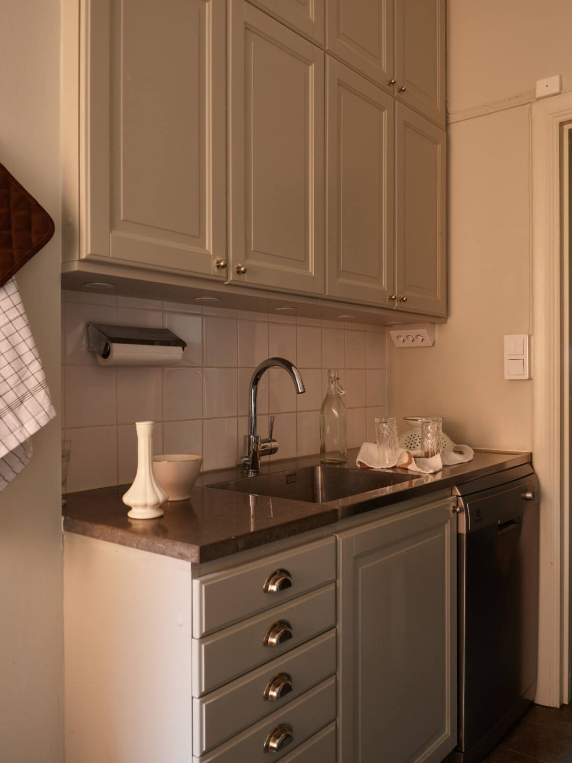 A Calm Gray Color Palette in a Charming Stockholm Apartment 15 small kitchen double row upper cabinets