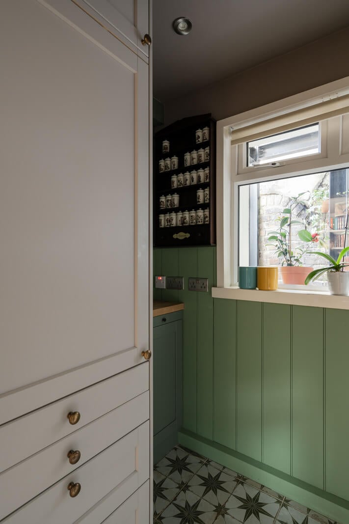 A Muted Color Palette in a Charming Ground Floor Apartment 11 small kitchen green paneling