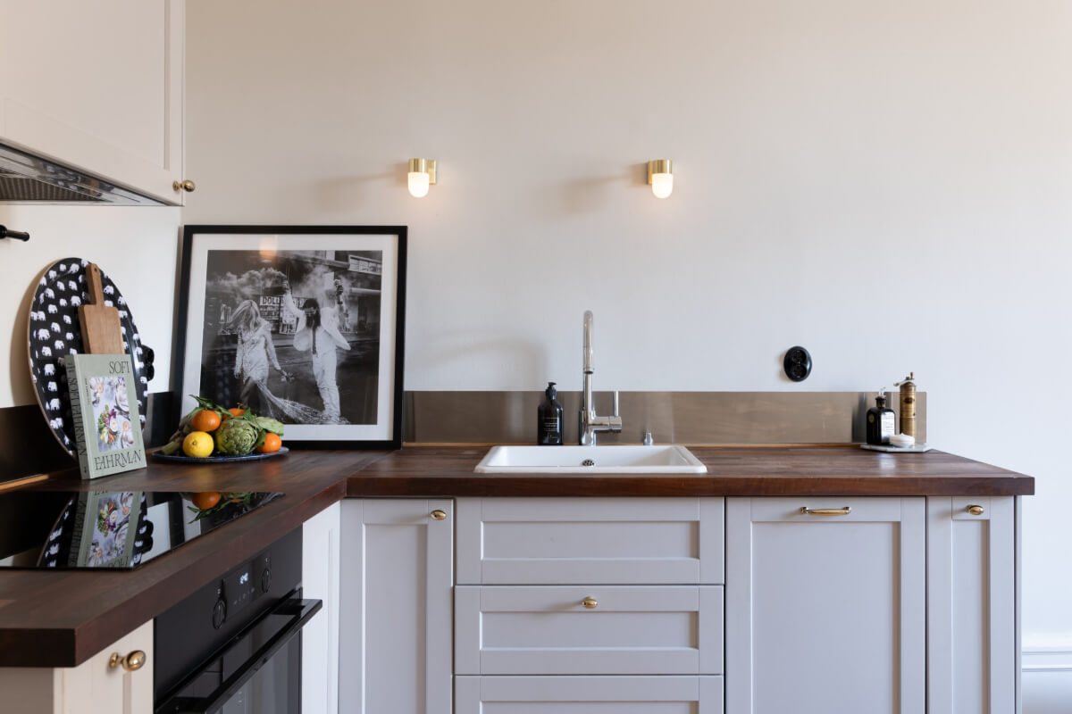 A Small Apartment Decorated in a Light Gray & White Color Palette 10 small kitchen light gray cabinets brass fittings