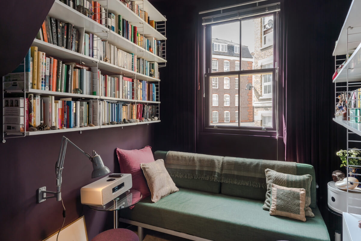 A Narrow Five-Story House with a Roof Garden in London's Clerkenwell 12 small living room aubergine walls green sofa bookshelves