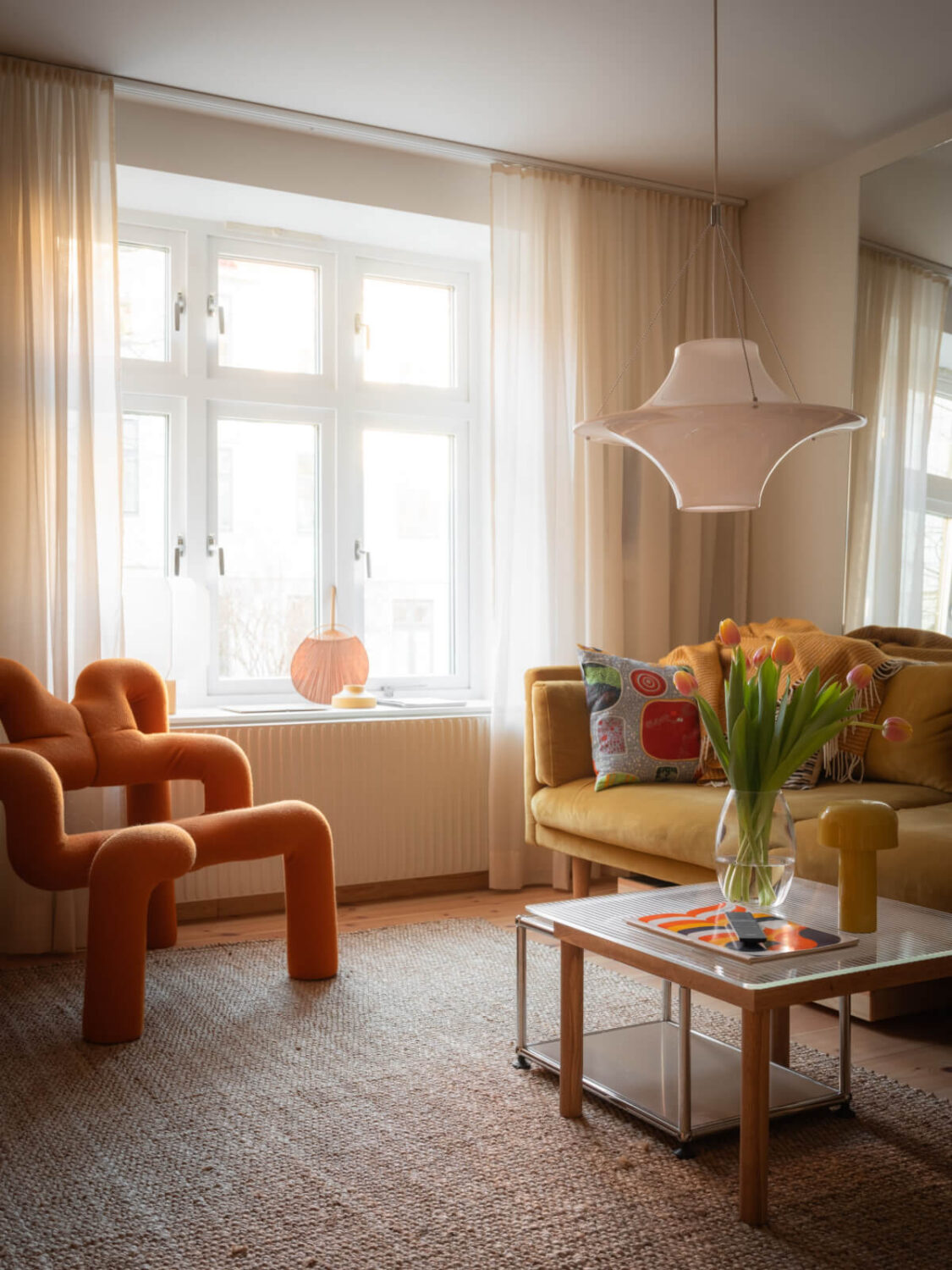 A Design Apartment in an Early 20th Century Building 2 small living room large rug orange chair
