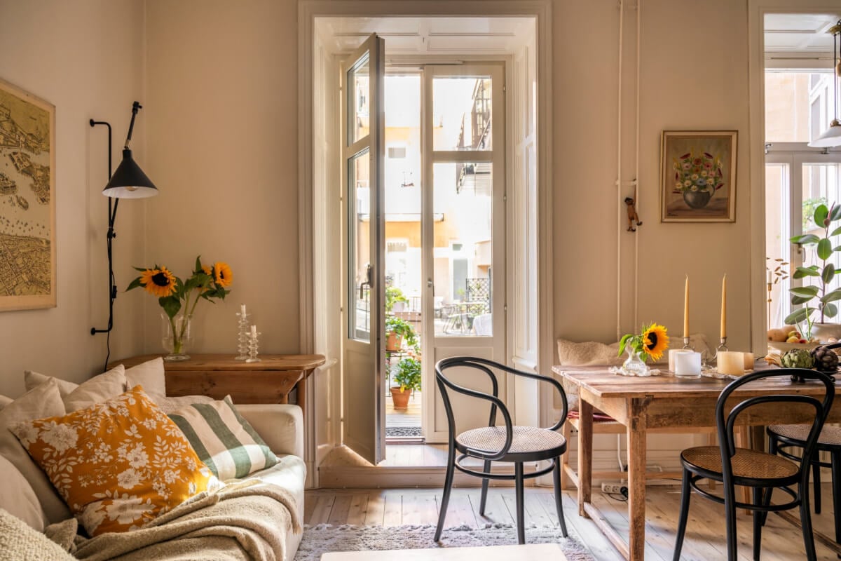A Cozy Small Apartment with Period Features and Lots of Storage 5 small living room rustic wooden dining table glass doors to terrace