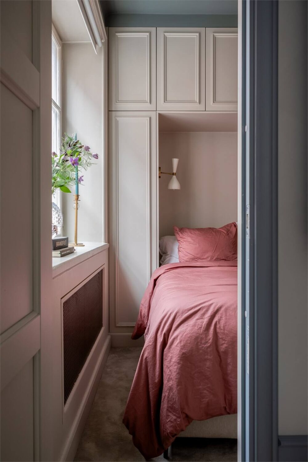 A Small Stockholm Apartment with a Blue Shaker Kitchen 17 small neutral bedroom with wardrobes around the bed