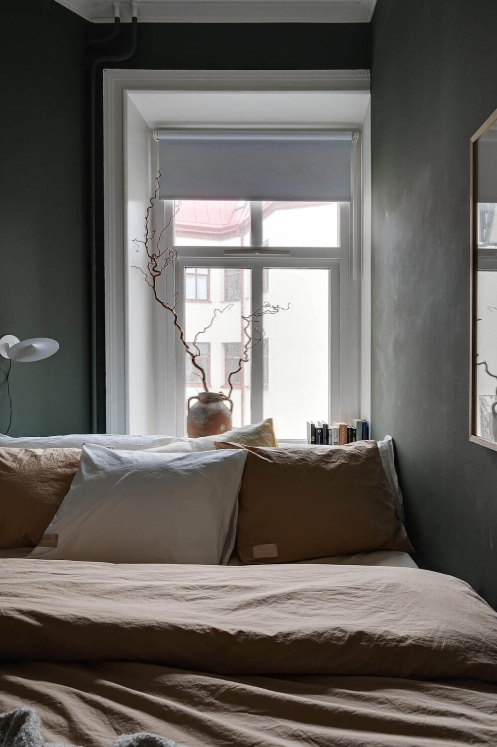 A Gothenburg Apartment with a Small Dark Green Bedroom 23 small window dark bedroom