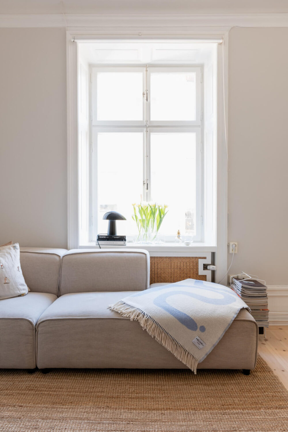 A Small Apartment Decorated in a Light Gray & White Color Palette 4 sofa detail