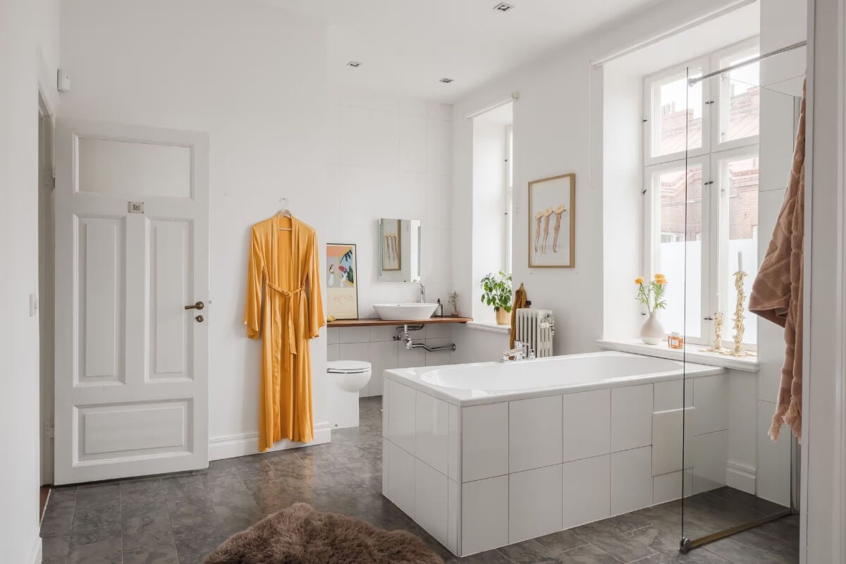 Grand Rooms and Period Features in a Malmö Apartment 21 spacious bathroom white tiles