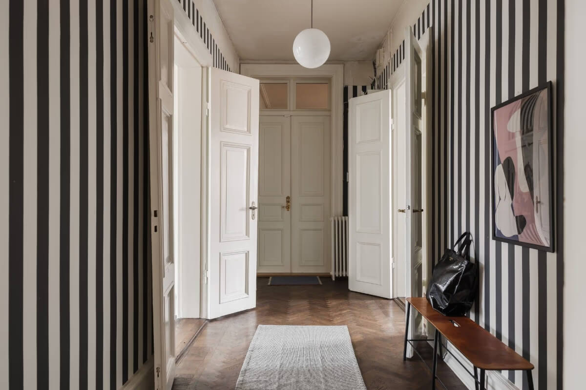 Grand Rooms and Period Features in a Malmö Apartment 23 spacious hall striped wallpaper