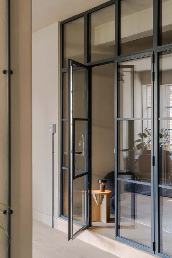 Soft-Colored Contemporary Interiors in a Warehouse Apartment 15 steel glass door