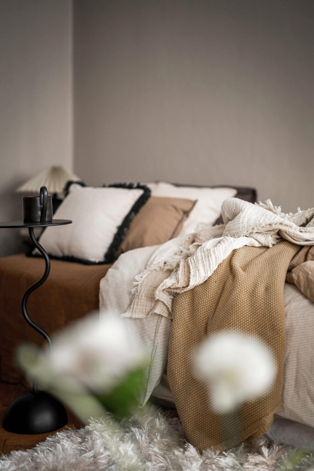 A Light Swedish Studio in an Early 20th Century Building 7 studio bed layered textiles