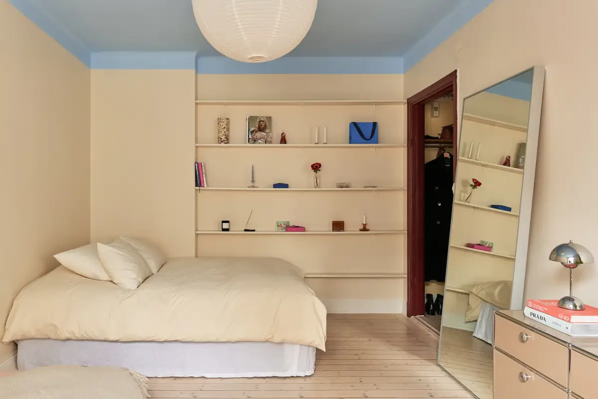 A Colorful Studio Apartment in Stockholm 3 studio yellow walls blue ceiling shelves