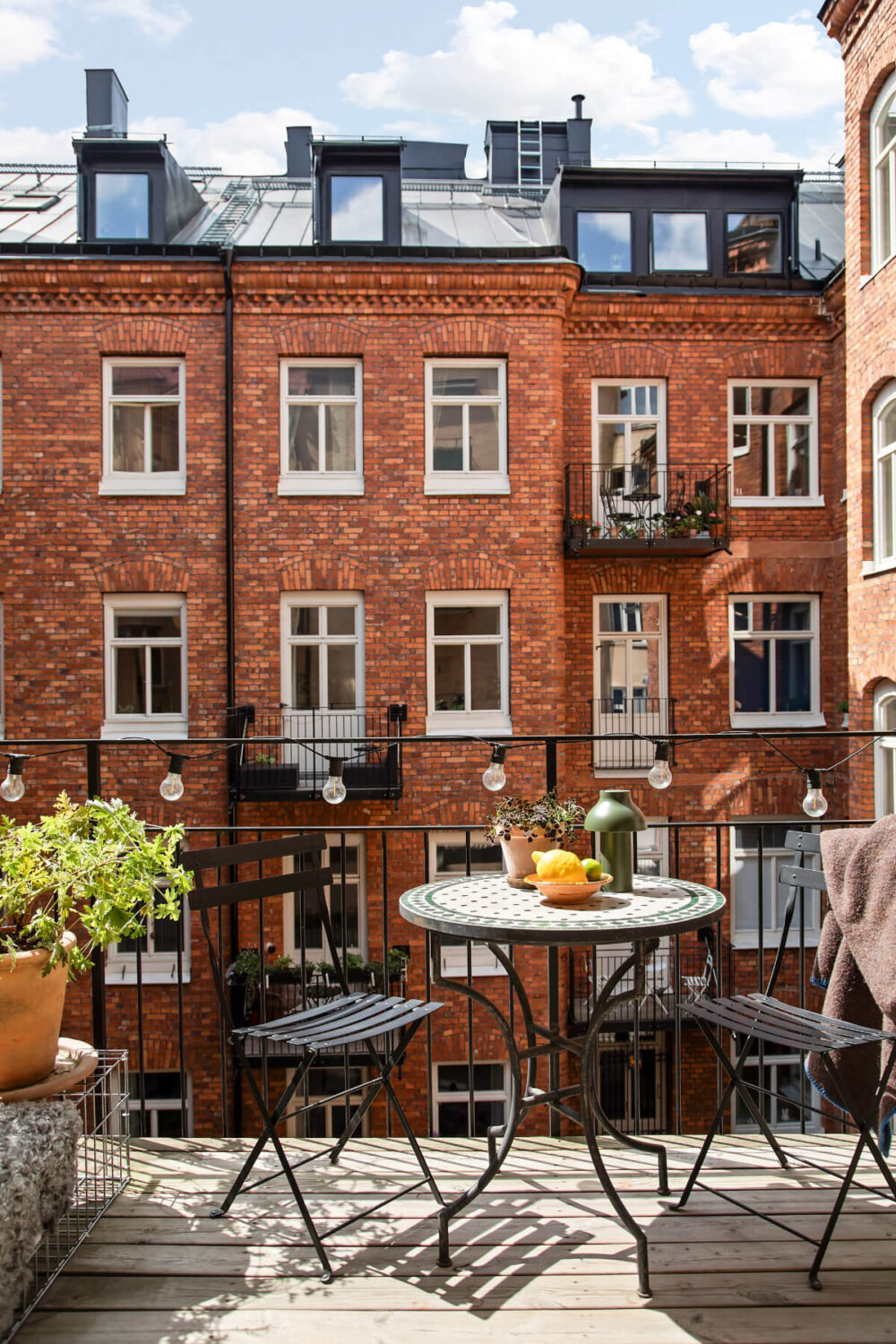 A Gray Studio Apartment with an Industrial Room Divider 4 sunny courtyard balcony