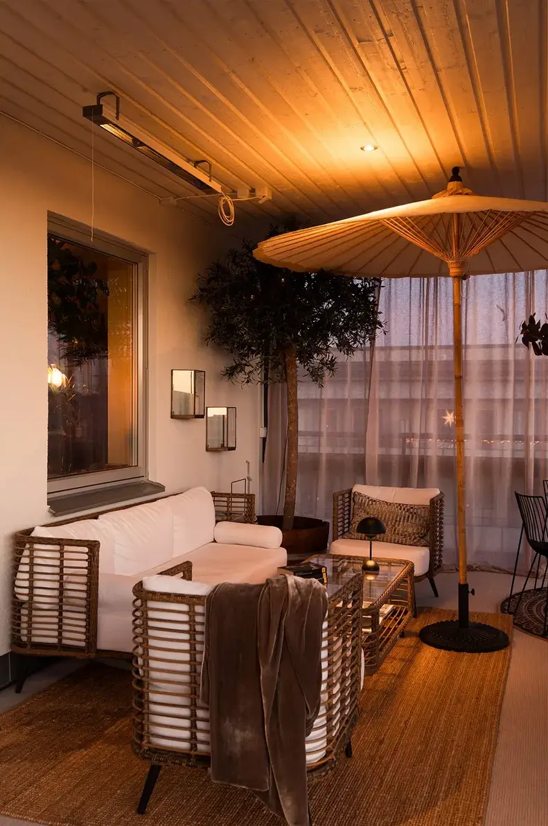 A Top Floor Swedish Apartment with a Huge Balcony 25 terrace sitting area at night jute rug
