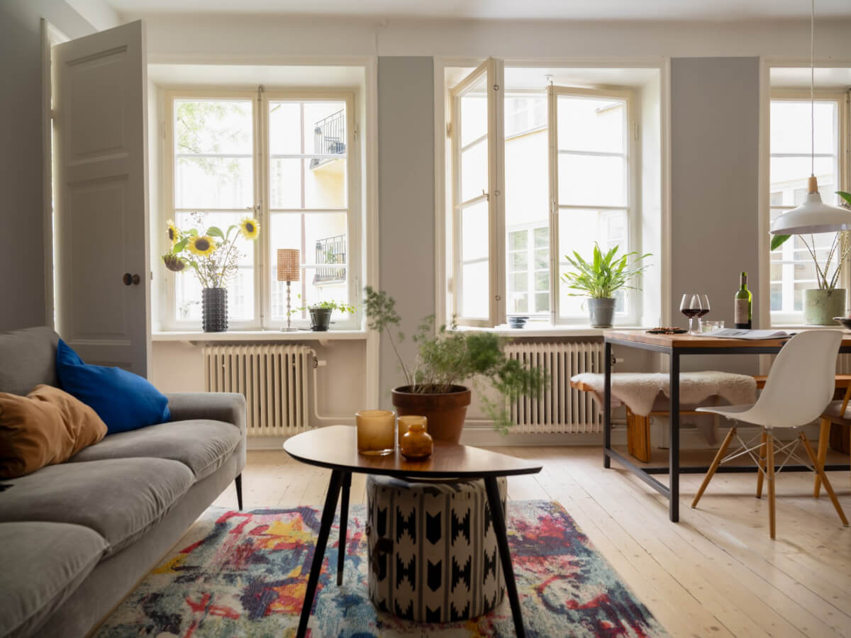 A Charming One-Bedroom Apartment in a 1920s Building 2 three large windows open plan living space wooden floor A Charming One-Bedroom Apartment in a 1920s Building