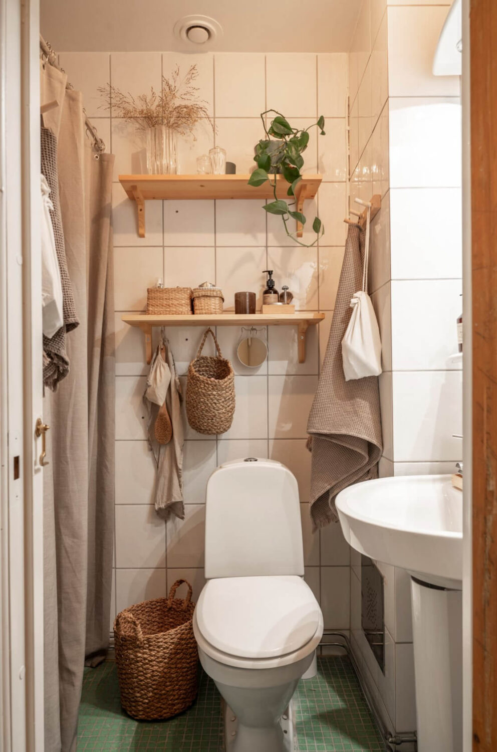 A Cozy Small Apartment with Period Features and Lots of Storage 22 tiny bathroom wooden shelves above toilet
