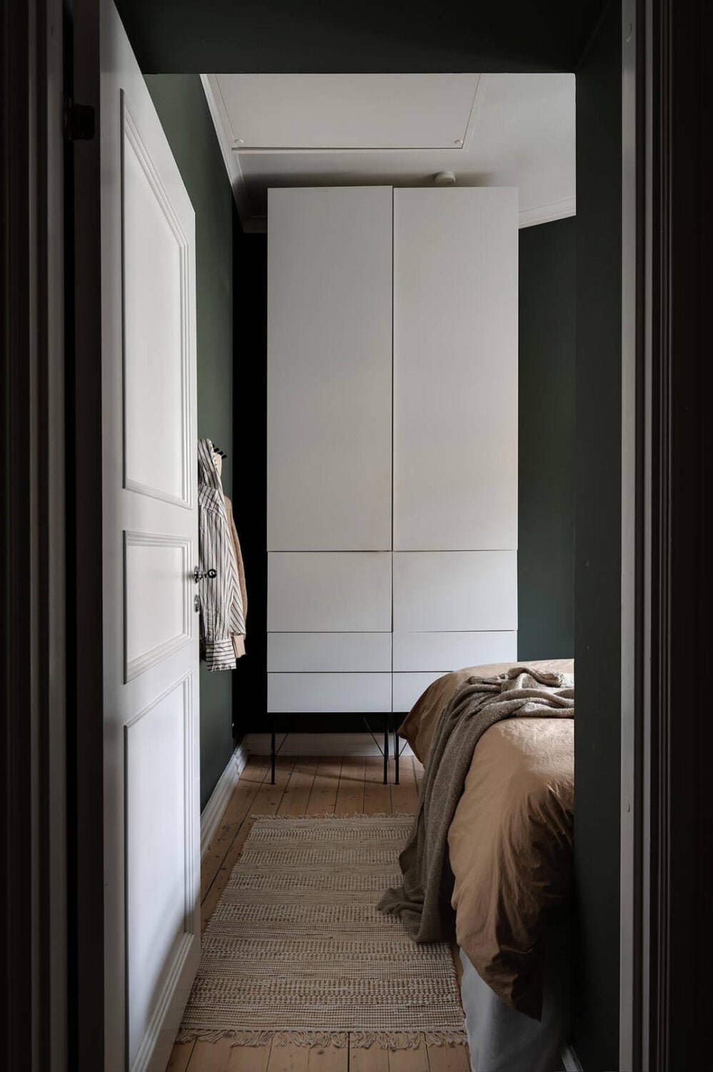 A Gothenburg Apartment with a Small Dark Green Bedroom 20 tiny dark bedroom wooden floor high wardrobe