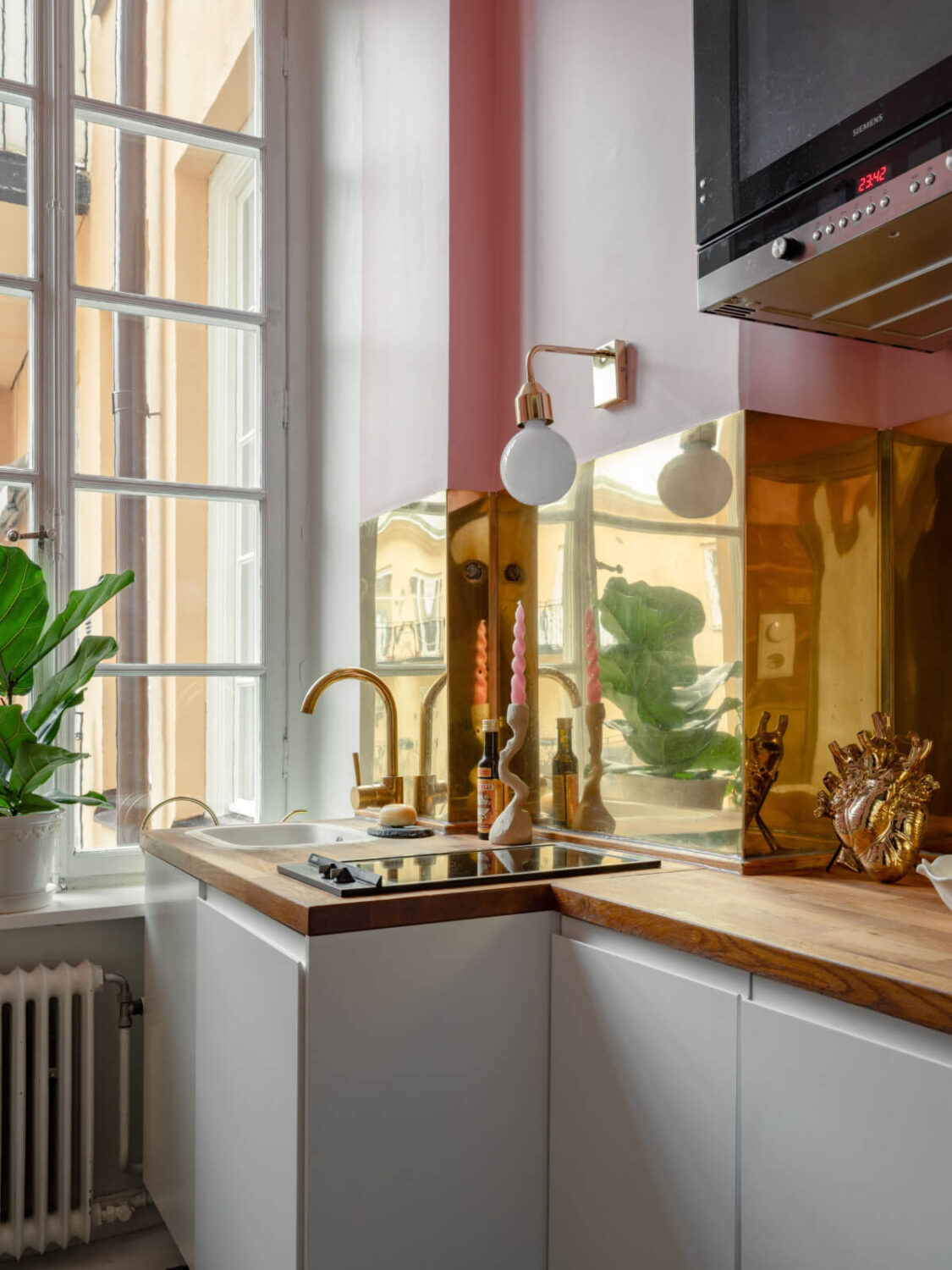 Small Space, Big Style: How to Design a Teeny-Tiny Kitchen That Works 14 tiny kitchen white cabinets pink walls gold backsplash
