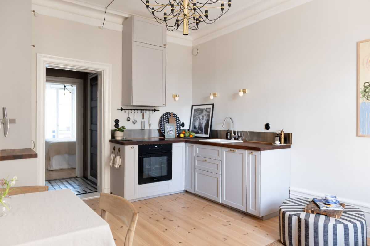 A Small Apartment Decorated in a Light Gray & White Color Palette 8 tiny living room with classic light gray kitchen