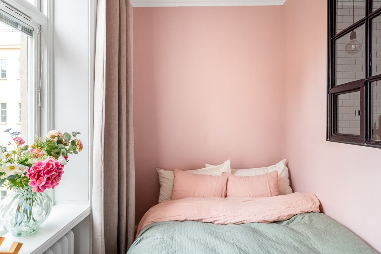 A Small Light-Filled Apartment with a Pink Bedroom 17 tiny pink bedroom inner window