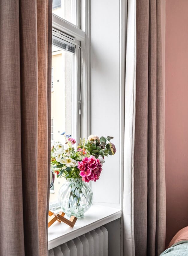 A Small Light-Filled Apartment with a Pink Bedroom 19 tiny pink bedroom window