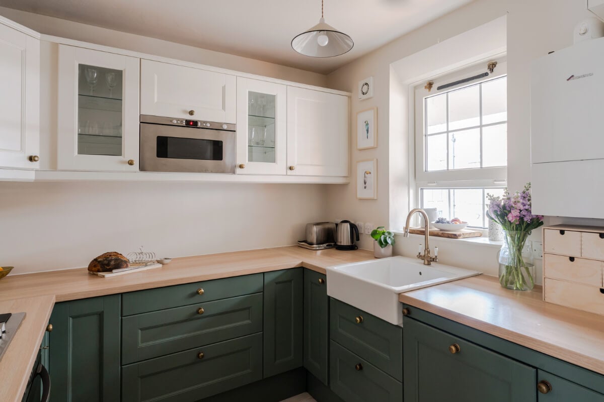 A Calm & Stylish Color Palette in a Small London Apartment 9 two tone kitchen sink under window