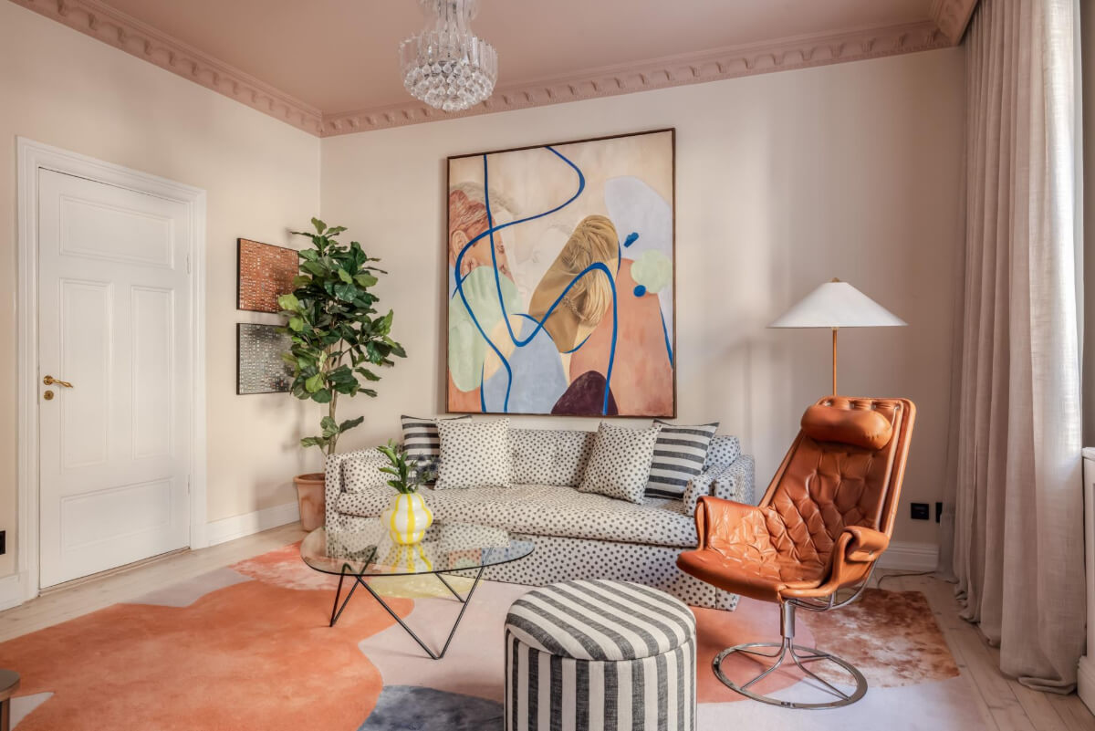 Best of 2025: Living Rooms 48 two tone pink living room large pastel rug dotted sofa striped ottoman