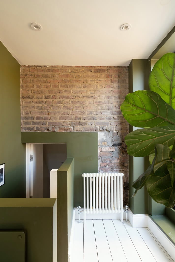 Contemporary Interiors and Preserved Details in an Early Victorian House 17 upper floor exposed brick white floorboards