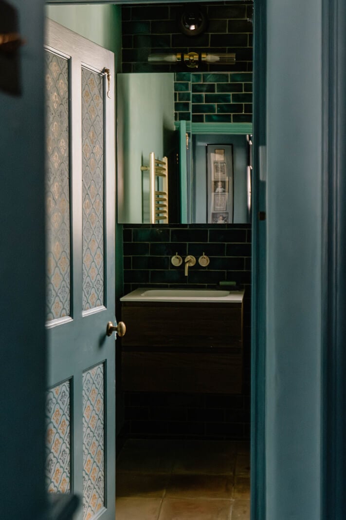 Moroccan-Inspired Designs in a Unique Artist Family Home in London 25 view into dark green bathroom