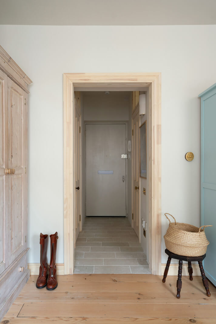 A Tiny Apartment with a Yellow Kitchen in London 9 view into hall with stone floor