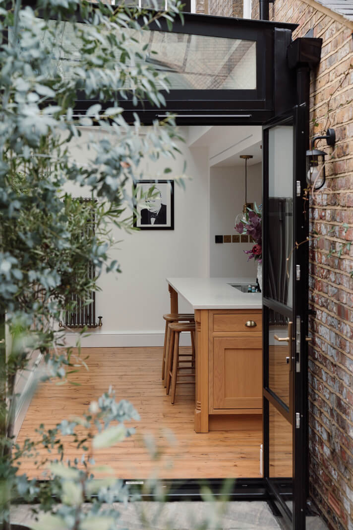 A Renovated Georgian House with an Extended Kitchen 9 view into kitchen glass doors