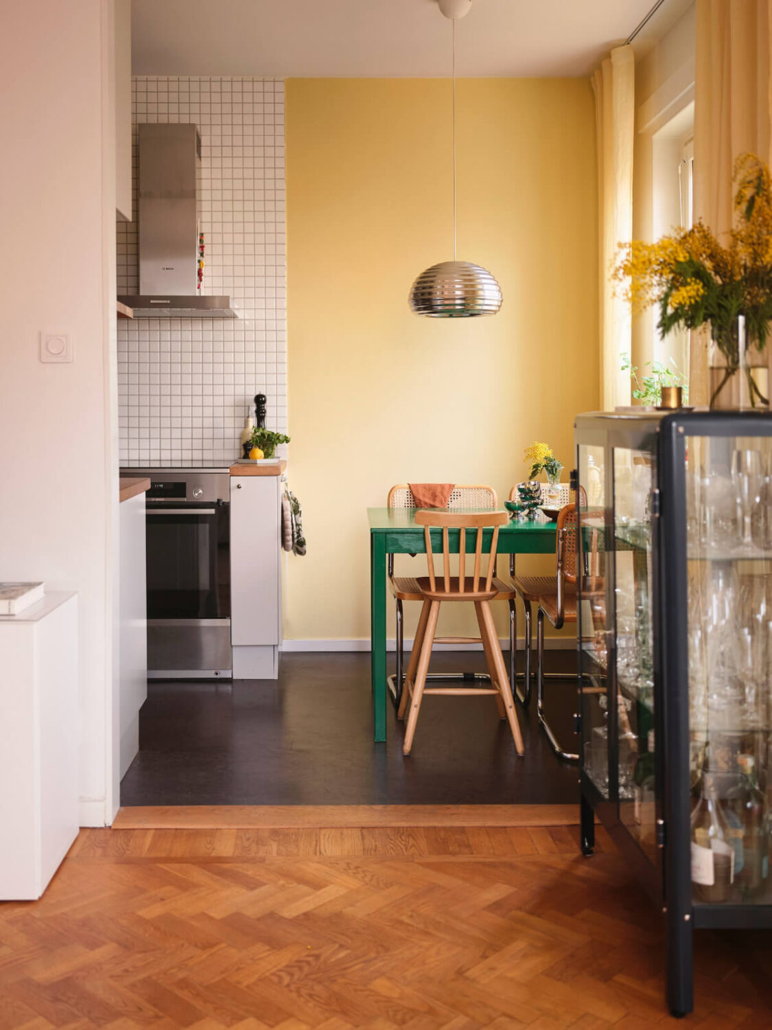 A Light Corner Apartment with Yellow Color Accents 12 view into kitchen yellow walls