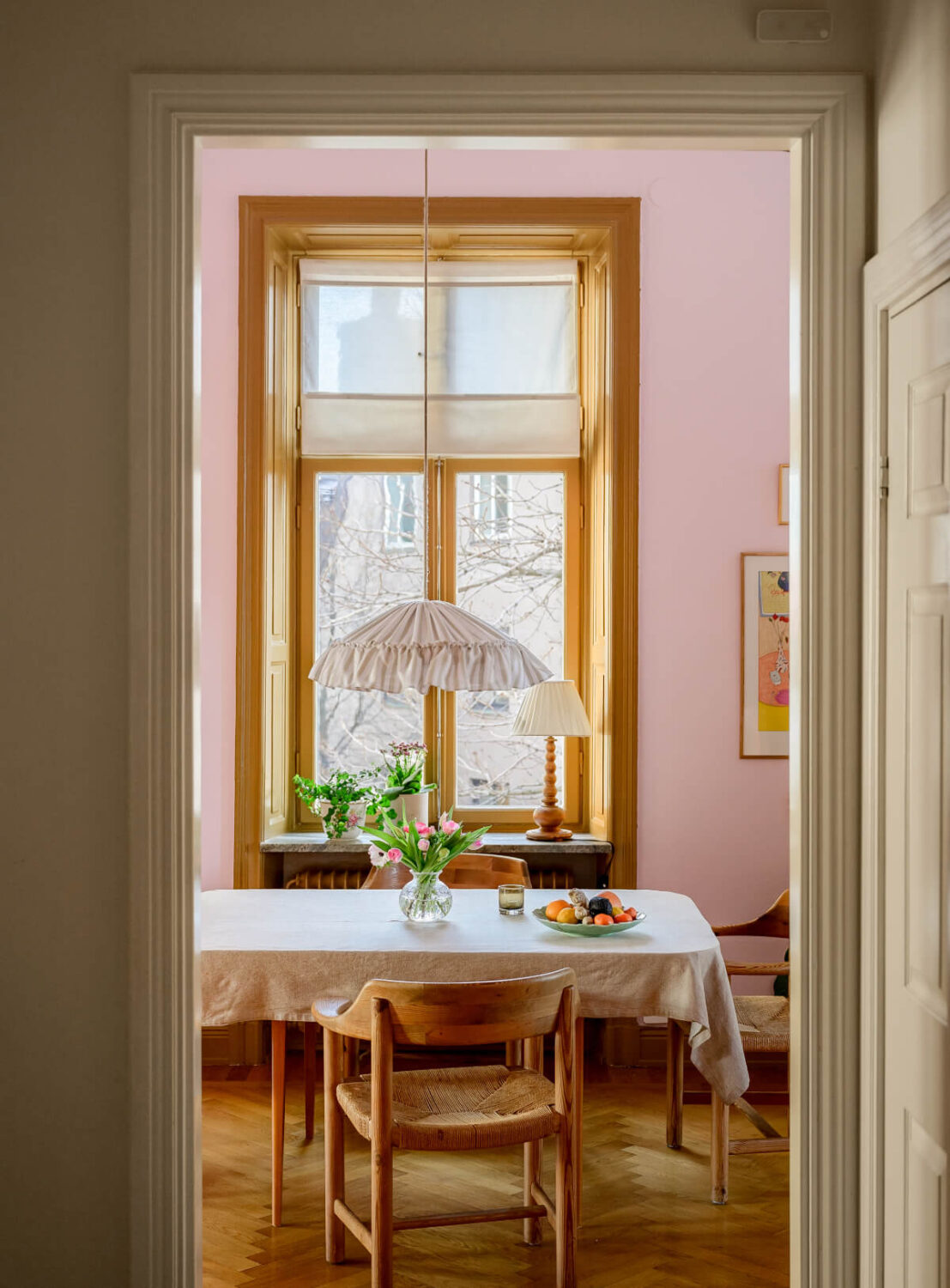 A Pink Living Room in a Light-Filled Stockholm Apartment 6 view into pink dining room