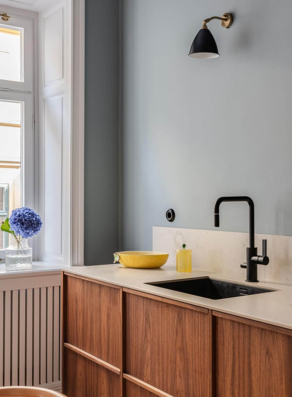 Pastel Colors and Contemporary Design in a Late 19th Century Apartment 12 walnut cabinets black fittings