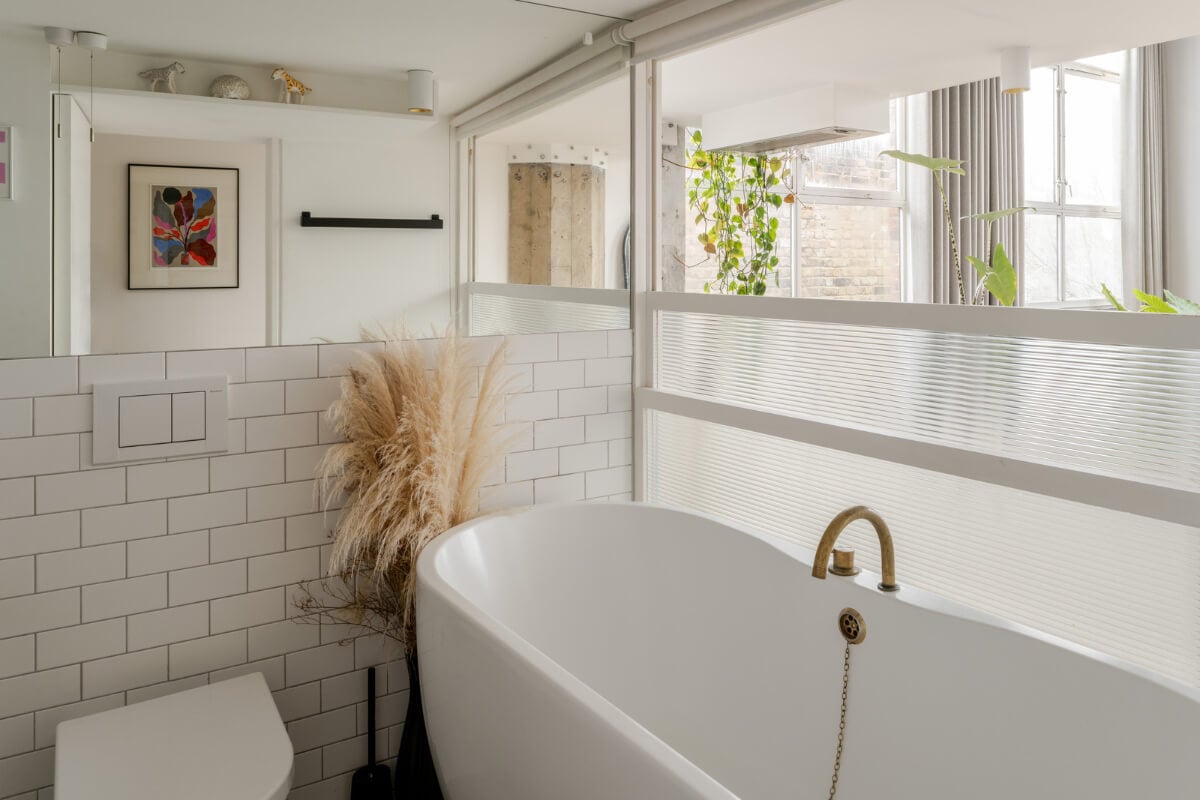 A Plant-Filled Loft Apartment in a Former Clothing Factory 12 white bathroom with bath
