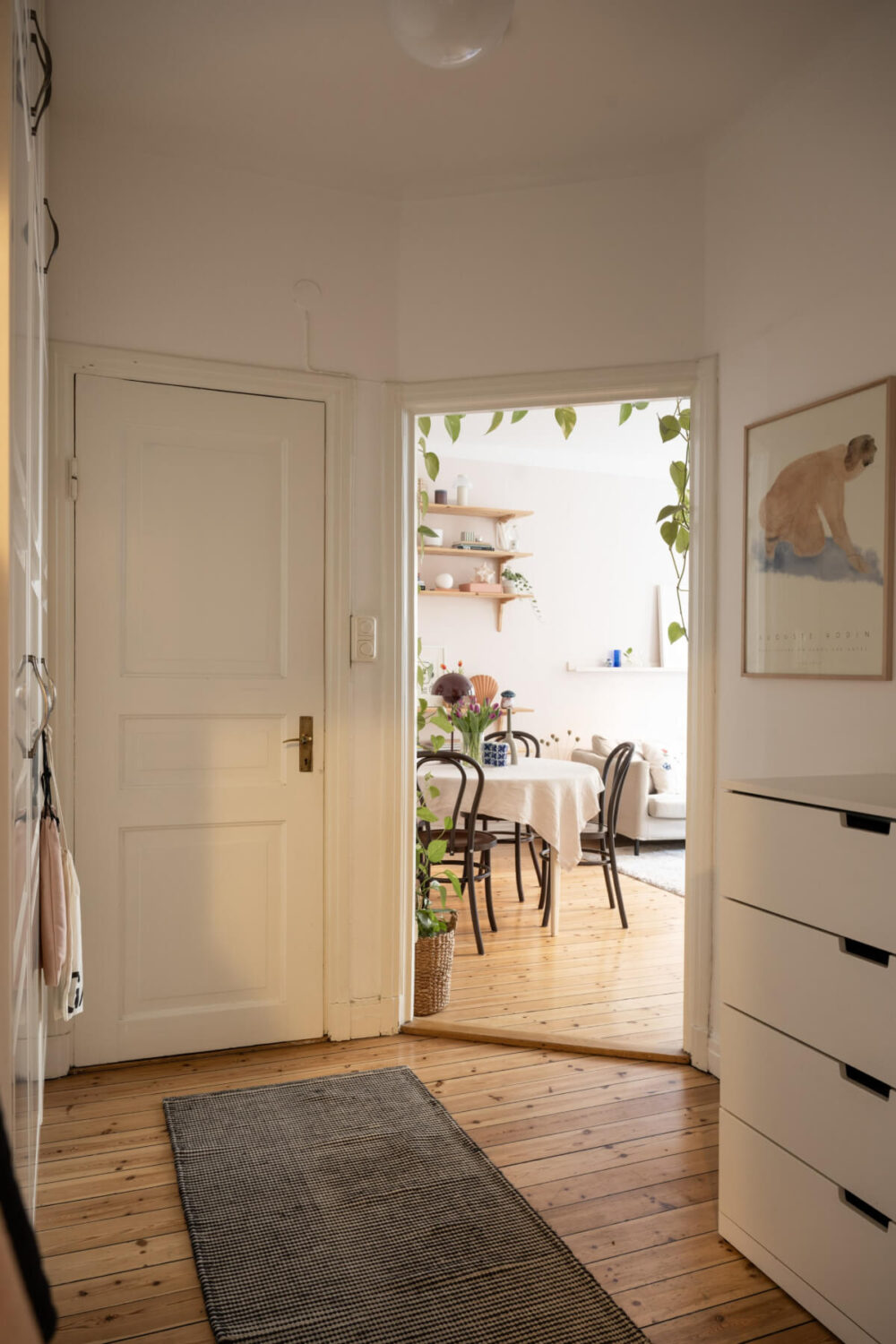 A Small Swedish Apartment with a Light Pink Living Room 17 white hall wooden floor