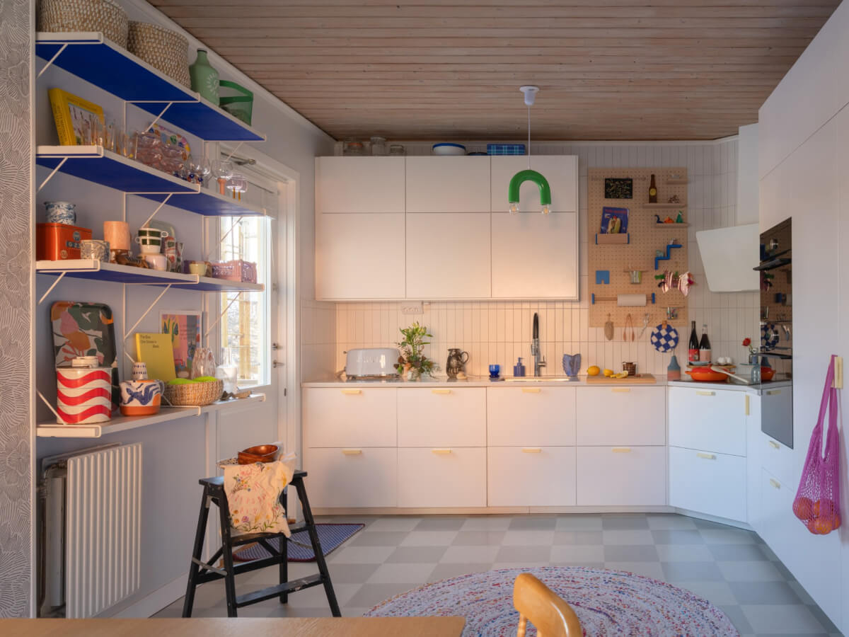 Colorful Decor in a Charming Family Duplex Apartment in Stockholm 11 white kitchen colorful accents checkerboard floor