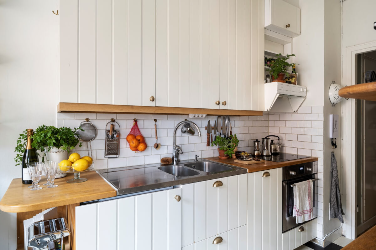 A Studio Apartment with Exposed Brick and Original Details 13 white kitchen wooden coutnertop
