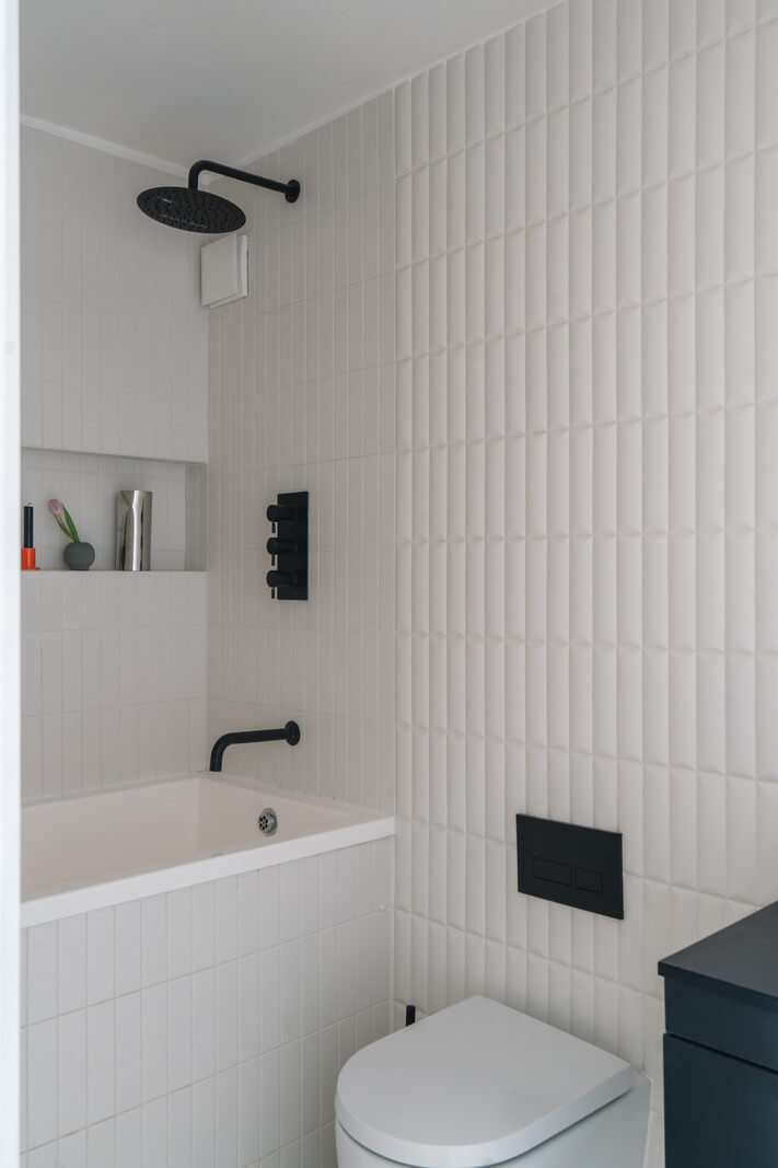 Contemporary Interiors in a Georgian Duplex Apartment in London 16 white tiles black fititng bathroom