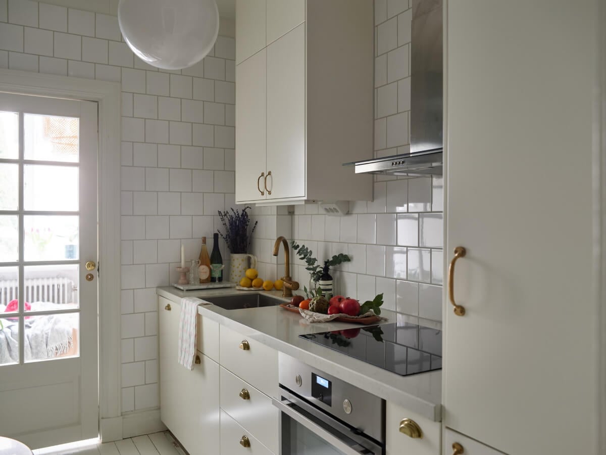 A Charming Small Apartment with a Fresh White Kitchen 9 white tiles kitchen